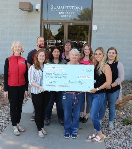 Namaqua Foothills Service League, group of people posing outside with a giant check