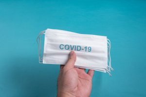 person holding COVID-19 mask