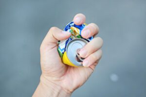 person holding recycling can