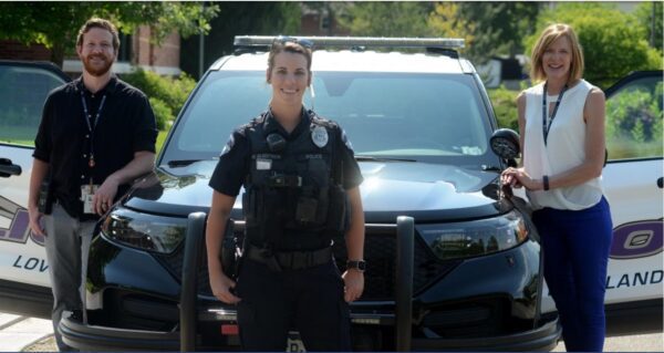 police officers around police car