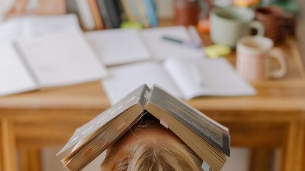 person with book on face