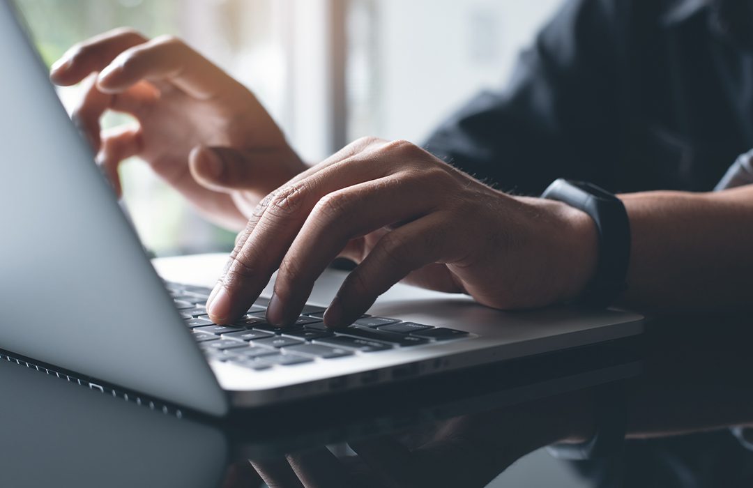 person typing on laptop