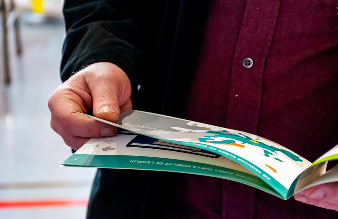 person looking at booklet