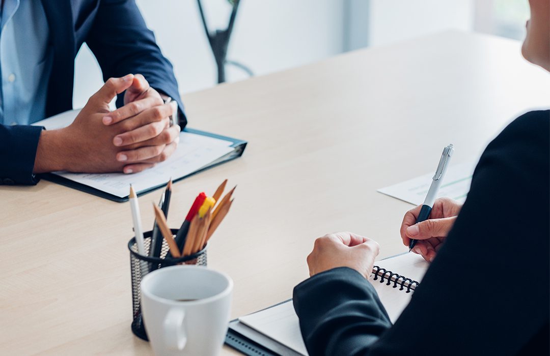 Business people taking notes in meeting