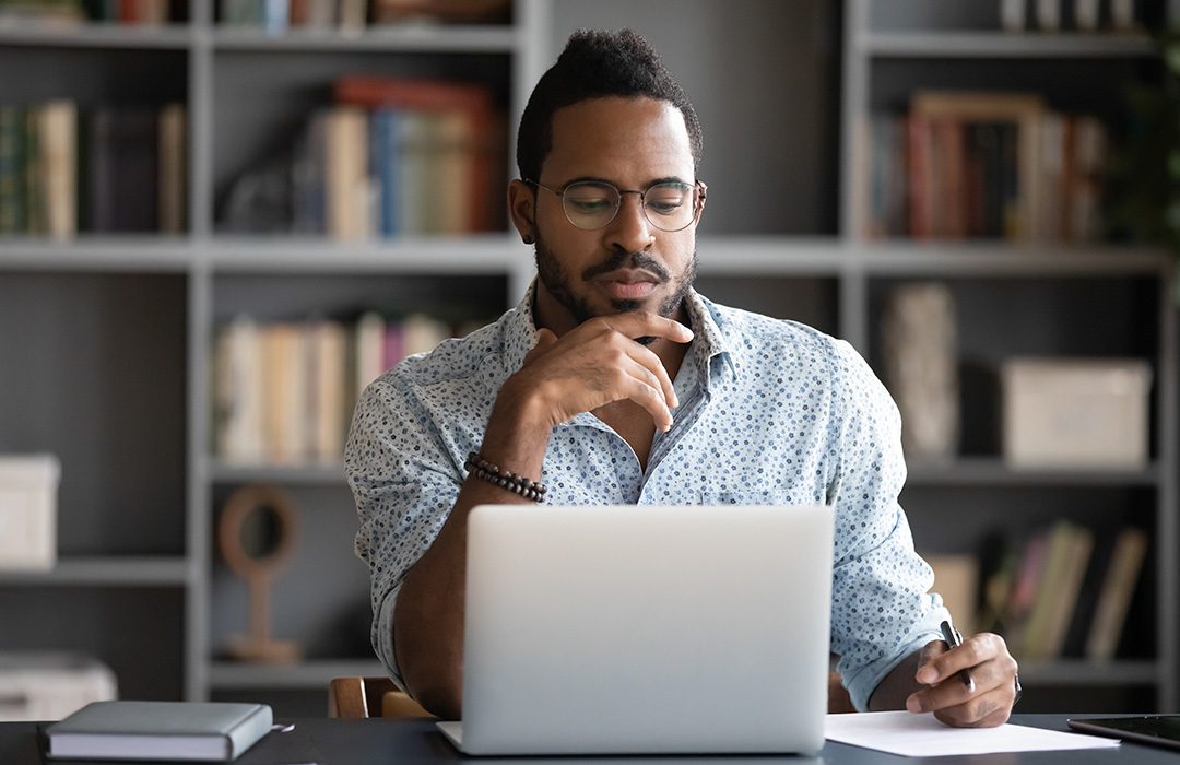 man using laptop for research