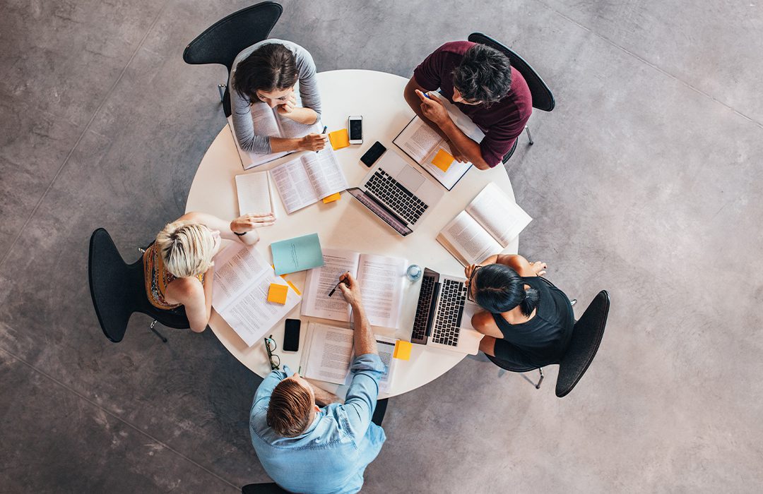 Group of people looking at research