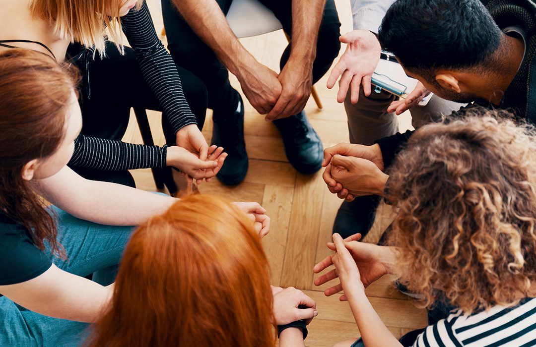 close up of people meeting at therapy together and talking