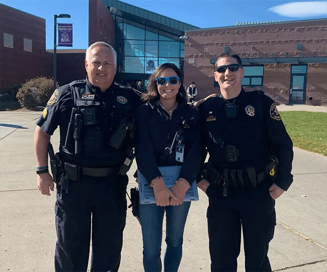 Co-Responder Team Bridges Mental Health Gap for Youth in Thompson School District, woman with two police officers standing in front of a building