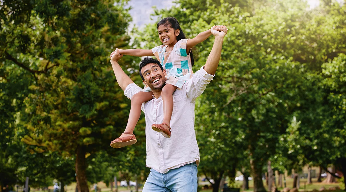 man with daughter on his shoulders