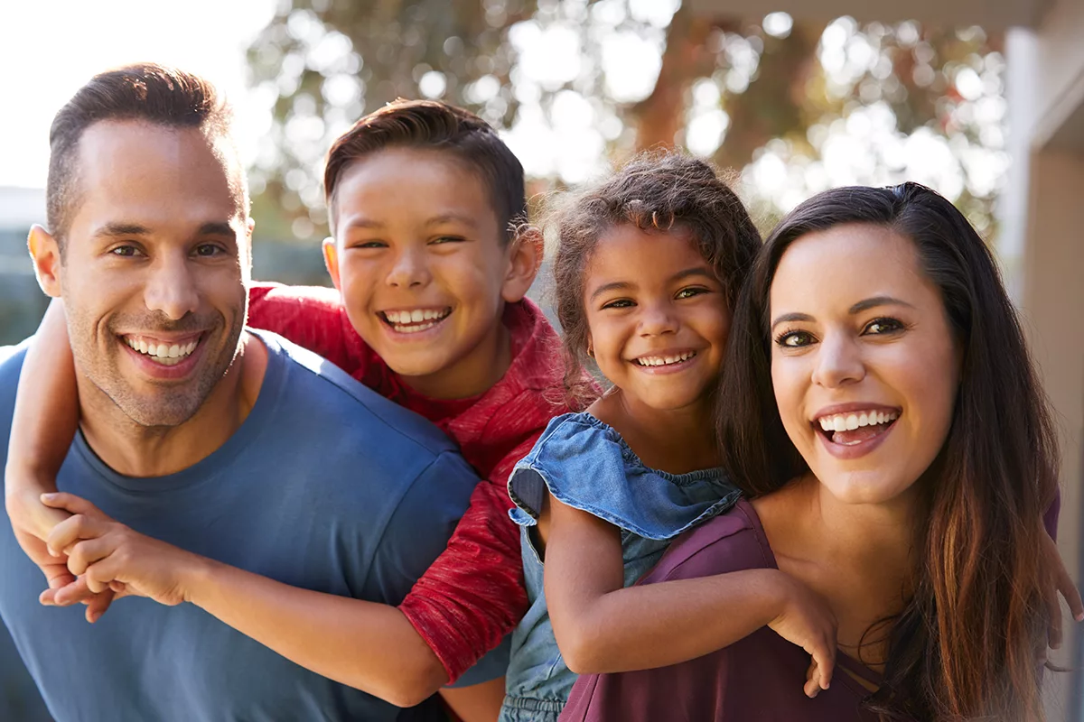 diverse family outside and smiling together