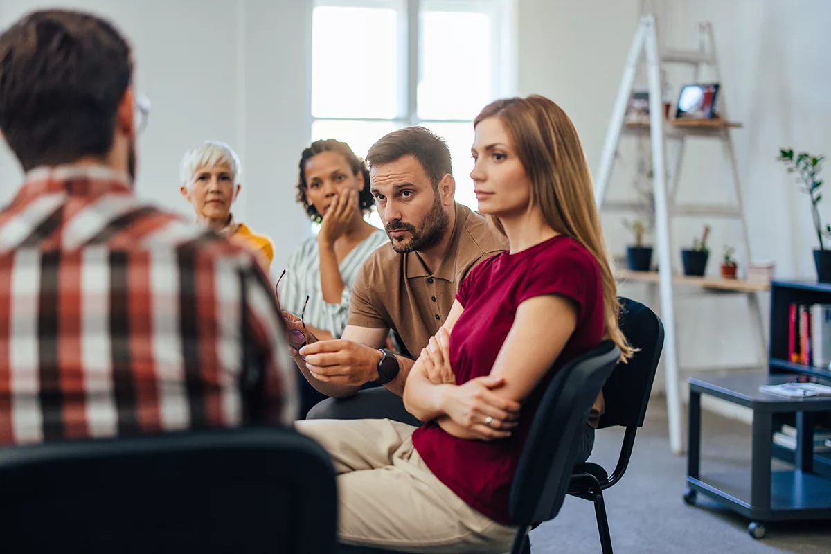 group of people sitting in circle at therapy