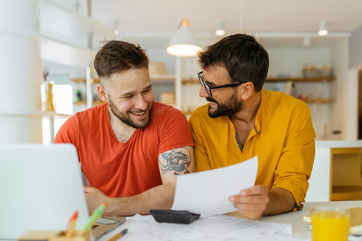 same sex male couple working on paperwork