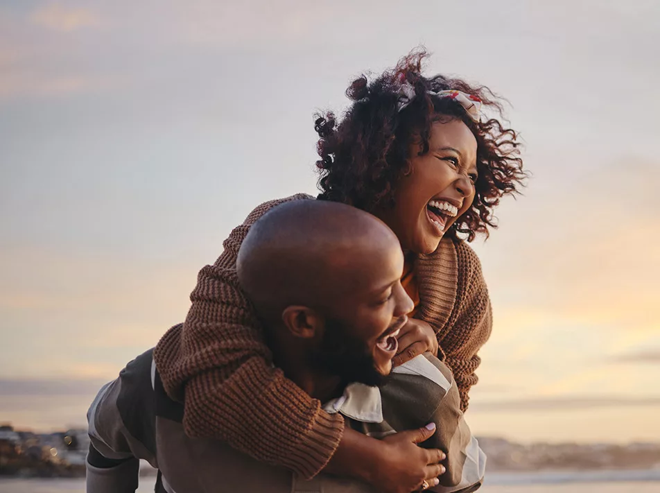 woman on mans back, hugging each other