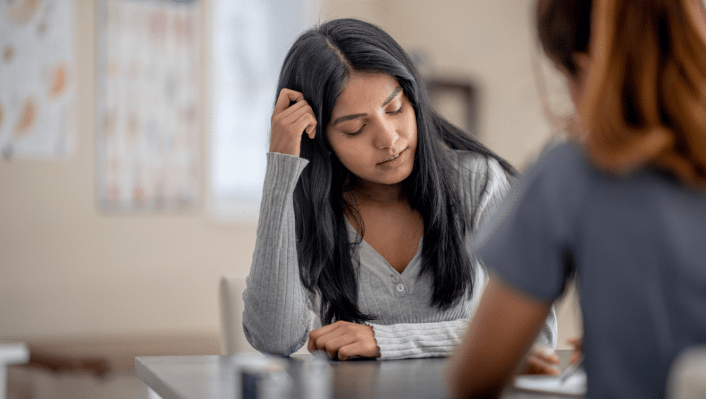 Latina woman talking to a therapist.