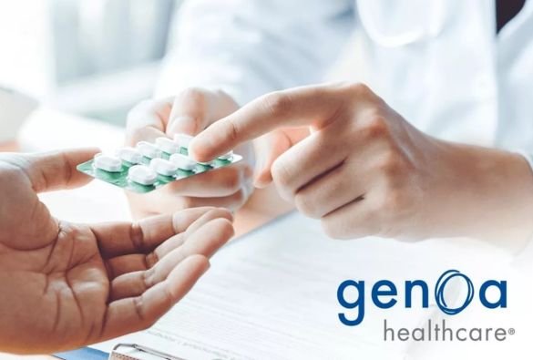A healthcare provider hands a blister pack of white pills to a patient. Documents and a pen are visible in the background, with the Genoa Healthcare logo in the lower right corner.