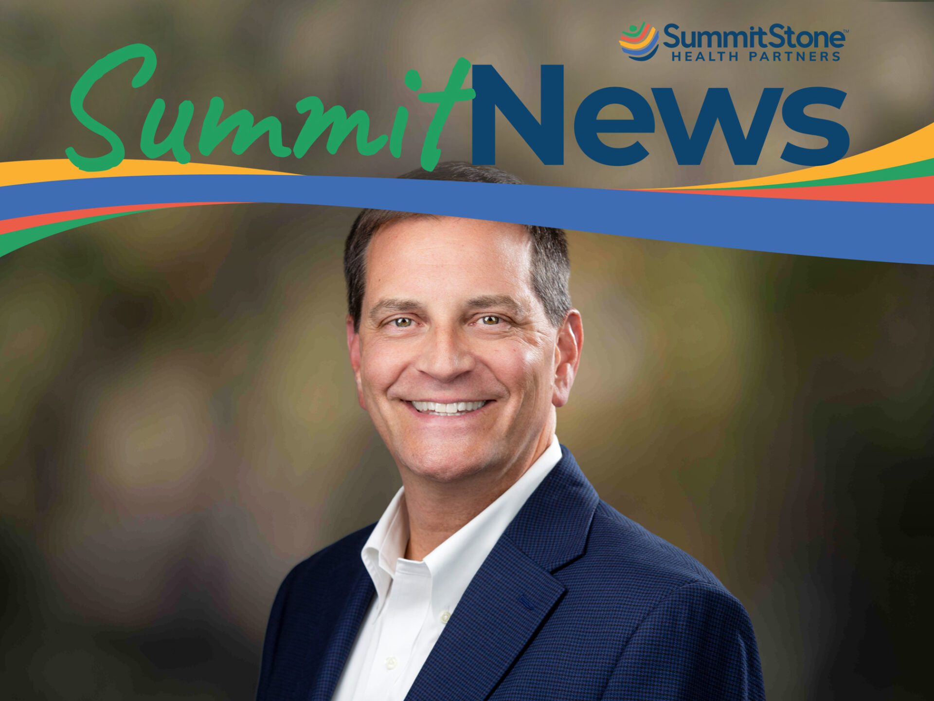 A smiling man in a navy blazer and white shirt stands in front of a blurred background. Above him is the SummitStone Health Partners logo and the text “Summit News” with colorful swoosh graphics.